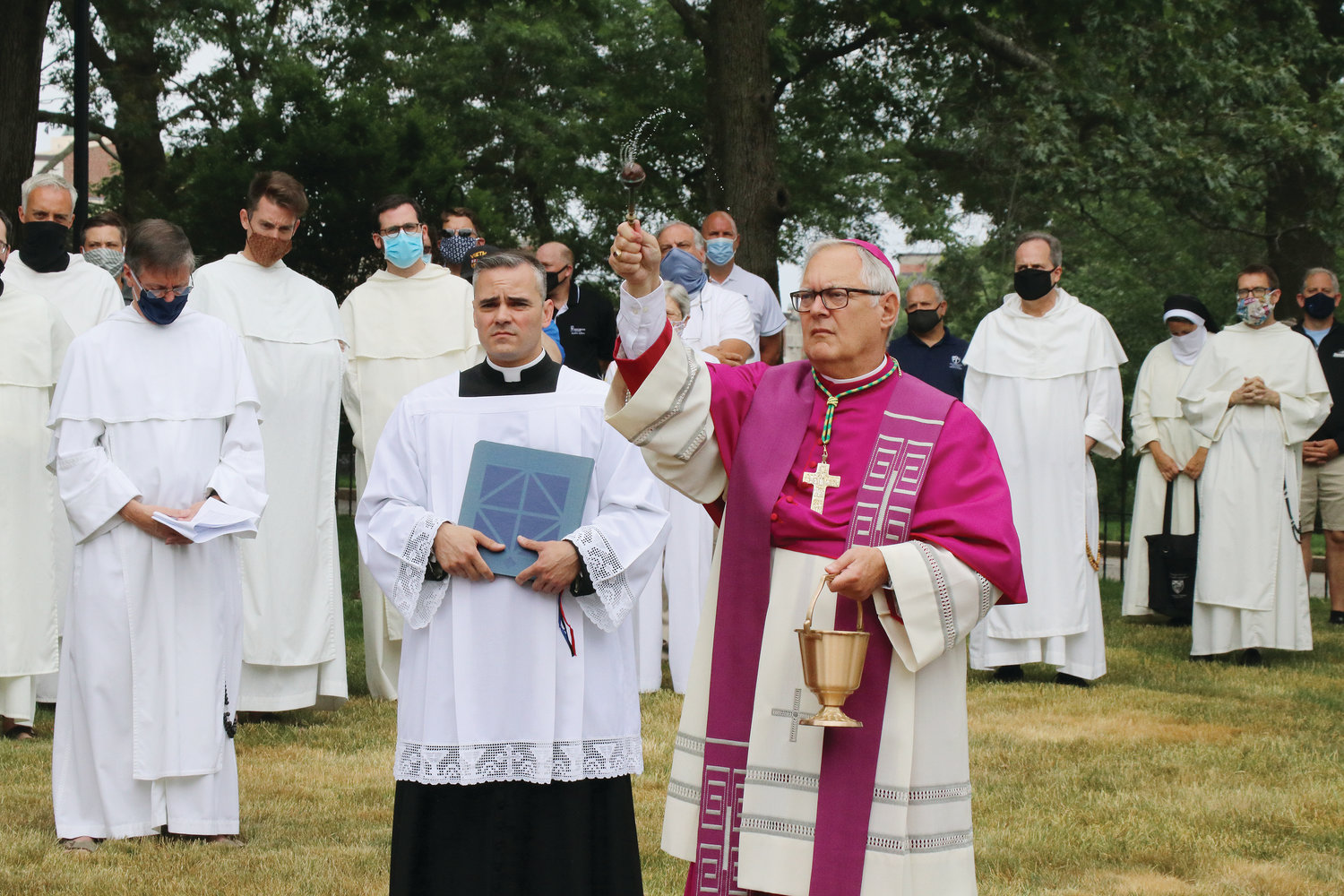 Bishop Thomas J. Tobin blesses the Dominican Cemetery’s grounds and central cross as he reconsecrates the sacred burial ground following the vandalism attack.